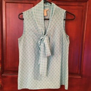 Turquoise and white patterned sleeveless top with neck bow